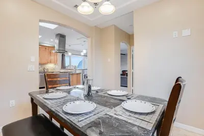 a kitchen and dining room with a table and chairs at Steps to the boardwalk & beach with AC, WiFi, spacious deck, prime location in San Diego