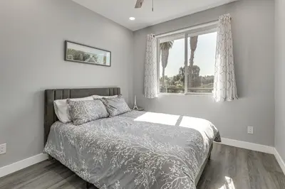 a bedroom with a bed and a window at 2 Mi to Downtown Escondido Apt with Balconies in Escondido