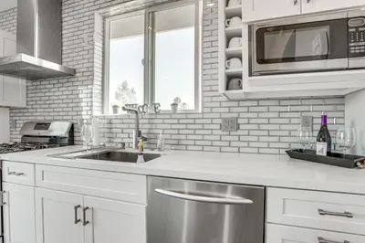 a kitchen with a sink and a microwave at 2 Mi to Downtown Escondido Apt with Balconies in Escondido