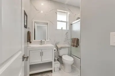 a white bathroom with a sink and a toilet at 2 Mi to Downtown Escondido Apt with Balconies in Escondido