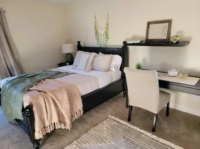 a bedroom with a bed and a desk and a chair at San Diego Oasis with Hot Tub, Gym, Outdoor Theater, Huge Yard in San Diego