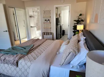 a bedroom with a large bed with white sheets and pillows at San Diego Oasis with Hot Tub, Gym, Outdoor Theater, Huge Yard in San Diego