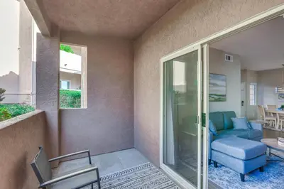 a living room with a couch and a chair at Sunny San Diego Condo with Pool Access Near Wineries in San Diego