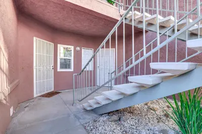 a staircase leading up to a building with a door at Sunny San Diego Condo with Pool Access Near Wineries in San Diego