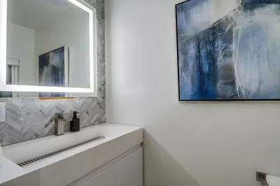 a bathroom with a sink and a mirror at Lux Escape 2 • Views Hot Tub Games Mini Golf in San Diego