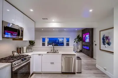 a white kitchen with a sink and a stove at Lux Escape 2 • Views Hot Tub Games Mini Golf in San Diego