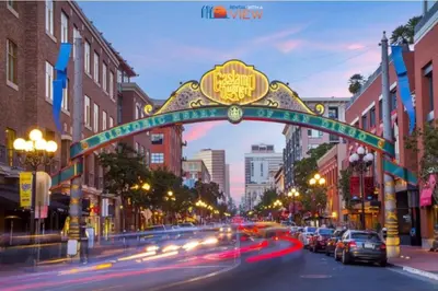 an arch over a city street with cars driving under it at Lux Escape 2 • Views Hot Tub Games Mini Golf in San Diego