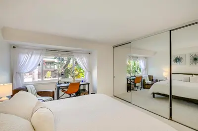 a bedroom with two beds and a mirror at San Diego Condo with Pool Access about 2 Mi to Beach! in San Diego