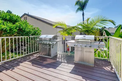 a grill and smoker on a deck with a fence at San Diego Condo with Pool Access about 2 Mi to Beach! in San Diego