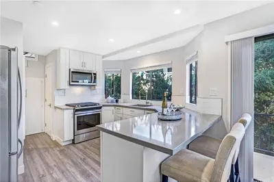 a kitchen with white cabinets and a large kitchen island at San Clemente Beach home walk to beach and downtown in San Clemente