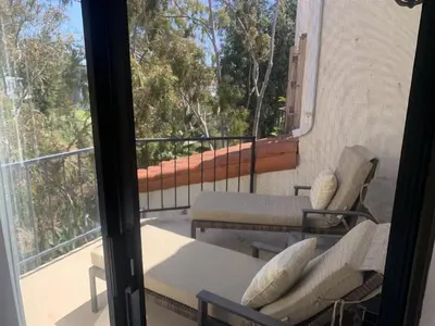 a balcony with two chairs and a table at San Clemente Beach home walk to beach and downtown in San Clemente
