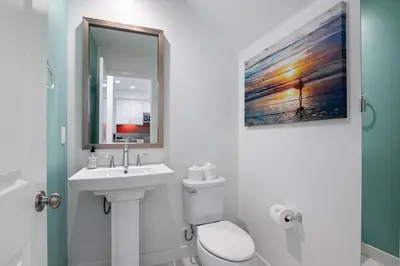 a bathroom with a sink and a toilet and a mirror at Better Two-Gether 2-bed 2,5-bath in Oceanside