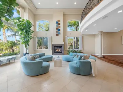 a large living room with blue couches and a fireplace at La Jolla Ocean Mansion in San Diego