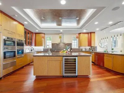 a large kitchen with wooden cabinets and a large island at La Jolla Ocean Mansion in San Diego