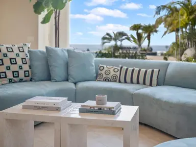 a living room with a blue couch and a coffee table at La Jolla Ocean Mansion in San Diego