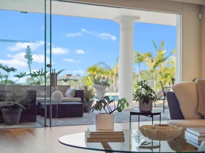 a living room with a couch and a table with plants at La Jolla Ocean Mansion in San Diego