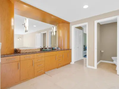 a bathroom with a large mirror and a sink at La Jolla Ocean Mansion in San Diego