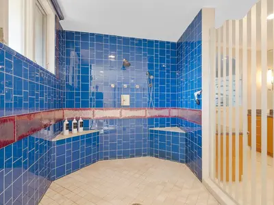 a blue tiled bathroom with a tub and a shower at La Jolla Ocean Mansion in San Diego