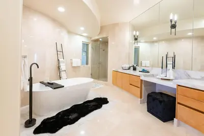 a bathroom with a large tub and a large mirror at La Jolla Ocean View Mansion 2 in San Diego