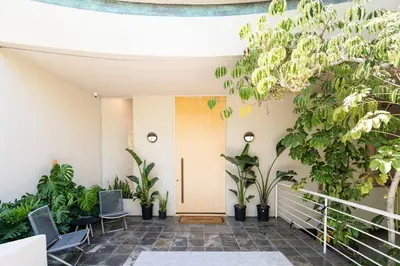 a hallway with potted plants and a door at La Jolla Ocean View Mansion 2 in San Diego