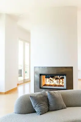 a couch in a living room with a fireplace at La Jolla Ocean View Mansion 2 in San Diego