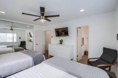 a bedroom with two beds and a ceiling fan at Mermaid's Penthouse in San Diego
