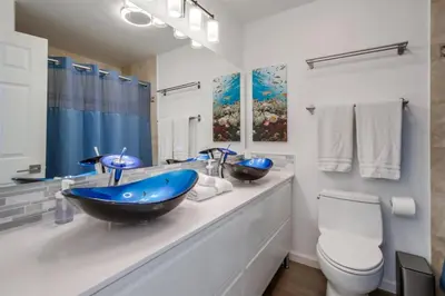 a bathroom with a blue sink and a toilet at Mermaid's Penthouse in San Diego