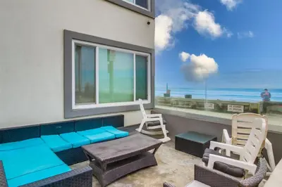 a room with a balcony with a view of the ocean at Mermaid's Penthouse in San Diego