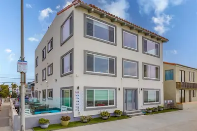 a white building with windows on a street at Mermaid's Penthouse in San Diego