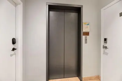 a elevator door in a building with a sign on it at Mermaid's Penthouse in San Diego