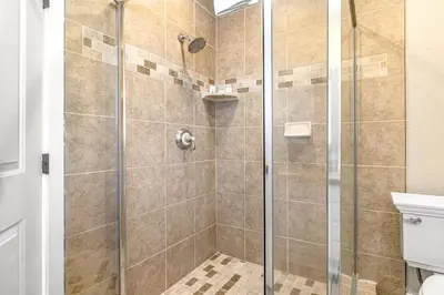 a shower stall with a glass door in a bathroom at Oceanfront Oasis in Newport Beach Steps to Balboa Park, Pier, and The Fun Zone! in Newport Beach