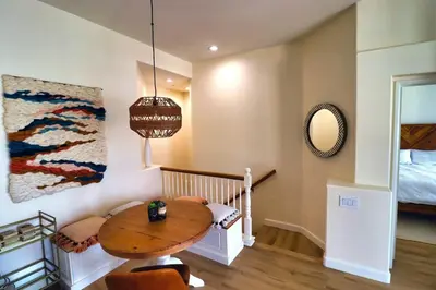 a small room with a table and a bed at Sweet Pea Place, 2 bed with pool in Encinitas