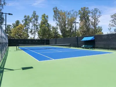 a tennis court with a bench on it at Irvine Inn Love - Lovely Furnished 3-bed Home in Woodbury in Irvine