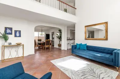 a living room with a blue couch and a table at Sunset Views Retreat in Vista