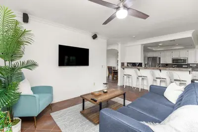 a living room with a blue couch and a table at Sunset Views Retreat in Vista
