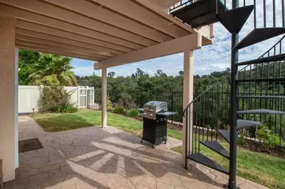 a barbecue under a pergola with a grill at Sunset Views Retreat in Vista