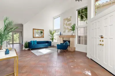 a living room with a blue couch and a fireplace at Sunset Views Retreat in Vista