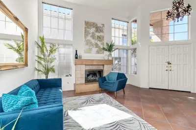 a living room with a blue couch and a fireplace at Sunset Views Retreat in Vista