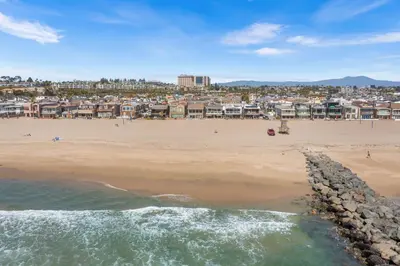 a view of a beach with people and buildings at Oceanfront 3BR Home with Pool Table & Patio in Newport Beach
