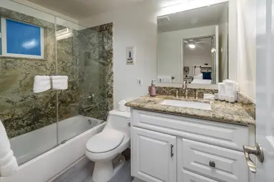 a bathroom with a toilet and a sink and a shower at Spacious 5BR Beach Home with Ocean Views in Newport Beach