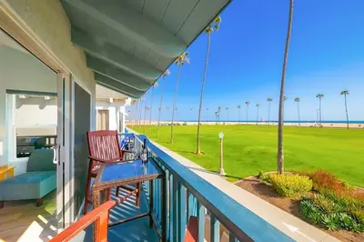 a porch with two chairs and a view of the beach at Condo in Newport Beach with Private Balcony and Ideal Location by the Pier in Newport Beach
