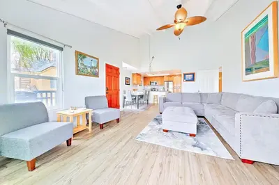 a living room with a couch and a table at Oceanfront Condo in Newport Beach with Private Balcony and Perfect Location by the Pier in Newport Beach
