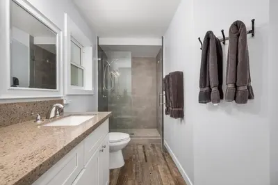a white bathroom with a toilet and a sink at Stunning Casa Surf House in Newport with Parking Stunning Casa Surf House in Newport in Newport Beach