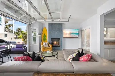 a living room with a couch and a fireplace at Giant Newport Duplex - Surf, Sand, Playground, Parking in Newport Beach