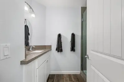 a white bathroom with a sink and a mirror at Perfect Surf Casa in Newport Near Beach and Pier in Newport Beach