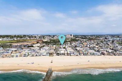 a kite flying over a beach with a city at Perfect Surf Casa in Newport Near Beach and Pier in Newport Beach