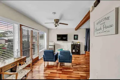 a living room with two blue chairs and a table at Rustic Coastal Retreat in Sunset Cliffs three beds & two baths in San Diego