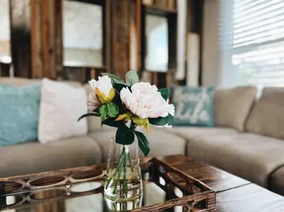 a vase of flowers on a table in a living room at Rustic Coastal Retreat in Sunset Cliffs three beds & two baths in San Diego