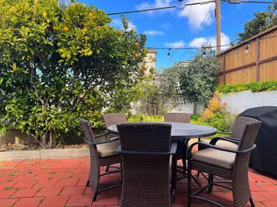 a patio table and chairs on a brick patio at Rustic Coastal Retreat in Sunset Cliffs three beds & two baths in San Diego
