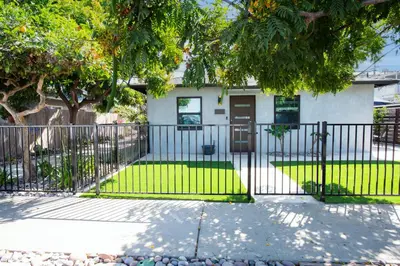 a black fence in front of a house at Modern 1 BR Cottage Steps 2Beach in San Diego